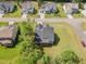 An aerial view of a home with a large yard and mature trees in a quiet residential neighborhood at 220 W Amber Oak Dr, Selma, NC 27576