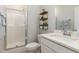 Bathroom featuring a walk-in shower, modern fixtures, and decorative shelves at 220 W Amber Oak Dr, Selma, NC 27576