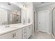Bright bathroom features dual sinks, white cabinets, tile floors, and a glass enclosed shower at 220 W Amber Oak Dr, Selma, NC 27576