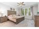 Spacious bedroom featuring a ceiling fan, light gray walls, and a large window with beige curtains at 220 W Amber Oak Dr, Selma, NC 27576