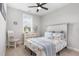 Comfortable bedroom showcasing large windows, soft lighting, and beach-themed decor at 220 W Amber Oak Dr, Selma, NC 27576