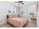 Relaxing bedroom featuring a ceiling fan, bright windows, and neutral decor at 220 W Amber Oak Dr, Selma, NC 27576