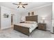 Relaxing bedroom with neutral walls, soft carpet, and a view into an adjoining bathroom at 220 W Amber Oak Dr, Selma, NC 27576