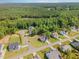Aerial view of a quiet neighborhood with mature trees and well-manicured lawns at 220 W Amber Oak Dr, Selma, NC 27576