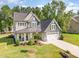Beautiful two-story home with a manicured lawn, two car garage, and covered front porch at 220 W Amber Oak Dr, Selma, NC 27576
