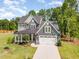 Beautiful two-story home with a manicured lawn, two car garage, and covered front porch at 220 W Amber Oak Dr, Selma, NC 27576