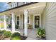 Charming front porch with a decorative wreath, stylish planters, and a small bench, perfect for welcoming guests at 220 W Amber Oak Dr, Selma, NC 27576