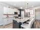 Well-appointed kitchen with a spacious island, granite countertops, and white cabinetry, creating a bright and inviting space at 220 W Amber Oak Dr, Selma, NC 27576