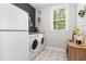Functional laundry room with modern appliances, ample counter space, and stylish décor, making chores a breeze at 220 W Amber Oak Dr, Selma, NC 27576