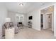 Bright living room with comfortable seating, a wall-mounted TV, and an open doorway at 220 W Amber Oak Dr, Selma, NC 27576