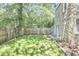 A charming backyard featuring lush lawn, wood fence, and stone accents at 2203 University Dr, Durham, NC 27707