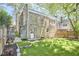 Backyard view with stone house, short stairs, and partial wooden fence at 2203 University Dr, Durham, NC 27707