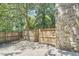 The backyard of the home features a classic stone design and gated wood fence at 2203 University Dr, Durham, NC 27707