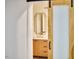 Chic bathroom featuring light wood vanity, gold framed mirror, and a view into the marble tiled shower at 2203 University Dr, Durham, NC 27707