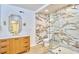 Modern bathroom features a sleek vanity, gold fixtures, and a walk-in shower with marble-style tile at 2203 University Dr, Durham, NC 27707