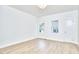 A bright bedroom features white walls and light wood floors offering a clean and airy aesthetic at 2203 University Dr, Durham, NC 27707