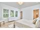 Bright bedroom showcasing natural light from multiple windows and modern furniture with light wood flooring at 2203 University Dr, Durham, NC 27707