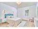 Bright bedroom featuring light wood floors, modern lighting fixture, and ample natural light from the window at 2203 University Dr, Durham, NC 27707