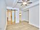 Bright bedroom with modern ceiling fan, light hardwood floors and sliding door to large closet at 2203 University Dr, Durham, NC 27707