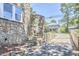 Unique stone arch detail with matching stone wall and exterior stairs at 2203 University Dr, Durham, NC 27707