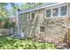 Close exterior stone and window view of the side and back of the home at 2203 University Dr, Durham, NC 27707