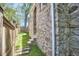 Side yard showcasing the stone exterior of the home and the manicured lawn at 2203 University Dr, Durham, NC 27707
