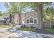 Stone exterior home featuring unique architectural details, with mature trees surrounding at 2203 University Dr, Durham, NC 27707