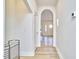 Hallway featuring an arched entryway, white walls and light wood floors for a bright, modern feel at 2203 University Dr, Durham, NC 27707