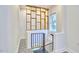 Hallway with unique tile flooring, staircase, and custom built-in shelving providing a modern aesthetic at 2203 University Dr, Durham, NC 27707