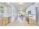 Bright open-concept kitchen and dining room with quartz countertops, stainless appliances, and hardwood floors at 2203 University Dr, Durham, NC 27707