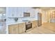 Modern kitchen with stainless steel appliances, white subway tile backsplash, and two-tone cabinetry at 2203 University Dr, Durham, NC 27707