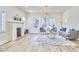 Inviting living room featuring a stone fireplace, neutral decor, and abundant natural light at 2203 University Dr, Durham, NC 27707
