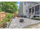 Charming backyard with a stone patio, fire pit, wooden fence, and landscaping, ideal for outdoor entertaining at 3007 Shopton Dr, Apex, NC 27502