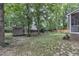 Backyard with a shed, partial fence, and grassy area, offering privacy and outdoor space at 3007 Shopton Dr, Apex, NC 27502