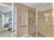 Tiled shower stall with glass door and chrome hardware, bedroom visible in background at 3007 Shopton Dr, Apex, NC 27502