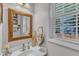 Bathroom with decorative wood-framed mirror, vanity with sink and natural light at 3007 Shopton Dr, Apex, NC 27502