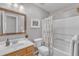 Bathroom with single sink vanity, a framed mirror, and a shower with a floral print curtain at 3007 Shopton Dr, Apex, NC 27502