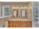 Bathroom featuring double sink vanity with wood framed mirrors, neutral countertops, and beige walls at 3007 Shopton Dr, Apex, NC 27502