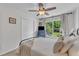Bright bedroom featuring a ceiling fan, a large window with natural light, and neutral décor at 3007 Shopton Dr, Apex, NC 27502