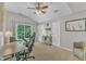 Bright bedroom with vaulted ceilings and ceiling fan is furnished with a desk and exercise equipment at 3007 Shopton Dr, Apex, NC 27502