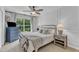 Cozy bedroom featuring a queen bed, dresser, ceiling fan, and large window with natural light at 3007 Shopton Dr, Apex, NC 27502