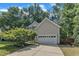 The side exterior of the home reveals an attached garage and established landscaping at 3007 Shopton Dr, Apex, NC 27502
