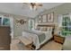 Main bedroom featuring a ceiling fan, large windows, and a comfortable king bed at 3007 Shopton Dr, Apex, NC 27502