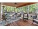 Comfortable screened-in porch with wood flooring, ceiling fan, and seating area perfect for relaxing outdoors at 3007 Shopton Dr, Apex, NC 27502