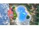 Overhead shot of backyard pool area with deck, outdoor dining set, and well-maintained landscaping at 302 Caraway Ln, Cary, NC 27519
