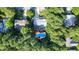 Aerial view showcasing the property surrounded by lush trees and a pool with outdoor living space at 302 Caraway Ln, Cary, NC 27519
