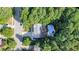 Aerial view showcasing the property surrounded by lush trees and a pool with outdoor living space at 302 Caraway Ln, Cary, NC 27519