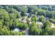 A high-angle view of the homes and the tree-lined street, highlighting the neighborhood's serene setting at 302 Caraway Ln, Cary, NC 27519