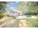 Wide shot of back yard and pool area featuring an outdoor dining set and well-maintained landscaping at 302 Caraway Ln, Cary, NC 27519