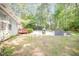 Expansive backyard featuring a sparkling swimming pool, outdoor seating, and beautifully landscaped surroundings at 302 Caraway Ln, Cary, NC 27519